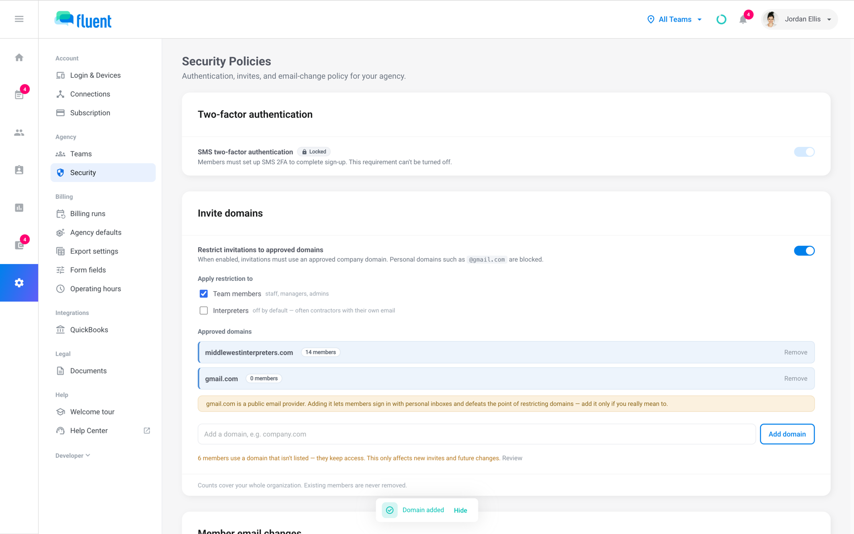 Invite domains card with the restriction on, 2 approved domains, and the public email provider warning